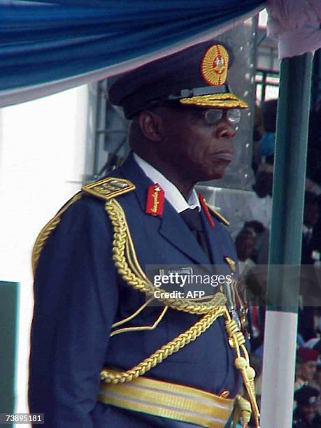 Nigerian President Olusegun Obasanjo dressed in an airforce ceremonial uniform takes salute during a farewell parade to mark airforce day in Abuja 16...