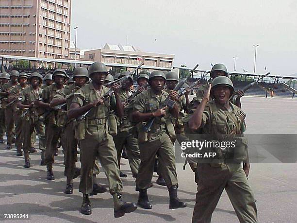 Officers and men of the Nigerian airforce give salute to President Olusegun Obasanjo during a farewell parade to mark airforce day in Abuja 16 April...