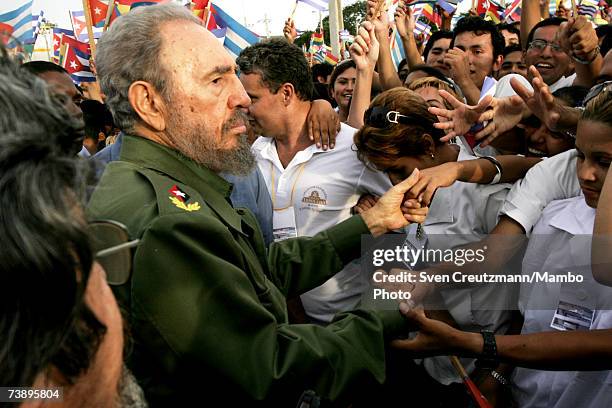 Fidel Castro shakes hands during a political rally on the day when Cuba celebrates the anniversary of his attack on the Monacada barracks in 1953,...