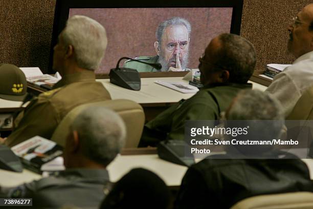 Cuban military officers attend a speech by Fidel Castro December 12, 2005 which is also projected on tv monitors, during the celebrations for the...