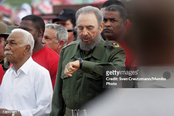 Fidel Castro looks at his watch during a political rally to celebrate the anniversary of his attack on the Monacada barracks in 1953 in this undated...