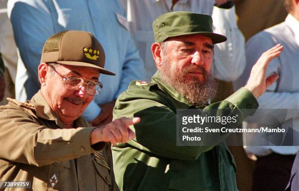 Fidel Castro and his brother Raul attend a May Day parade December 2, 1996 in Havana, Cuba.