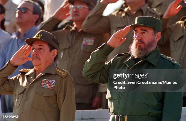 Fidel Castro and his brother Raul attend a parade December 2, 1996 in Havana, Cuba. Carlos Lage is at left.