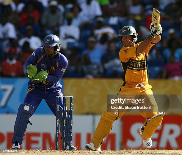 Ricky Ponting the Australia captain plays a shot as Kumar Sangakkara the Sri Lanka wicket-keeper looks on during the ICC Cricket World Cup 2007 Super...
