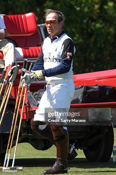 Actor Tommy Lee Jones puts on a glove during a competition with his Polo Team San Saba in the Stanford U.S. Open at International Polo Club Palm...