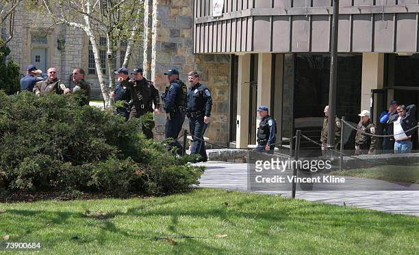 Police officers gather in front of McBryde Hall on the campus of Virginia Tech University after a shooting left at least 32 dead April 16, 2007 in...