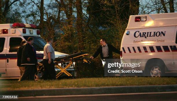 Ambulance drivers pack their gear after dropping victims of the mass shooting at the southwestern Virginia University, Virginia Tech at the Medical...