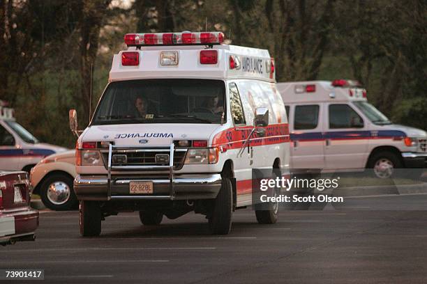 Ambulances sit outside the Medical Examiner's office where victims from the mass shooting at the southwestern Virginia University, Virginia Tech were...