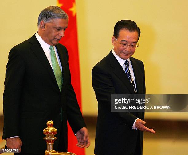 Visiting Prime Minister of Pakistan, Shaukat Aziz is shown the way forward by his Chinese counterpart Wen Jiabao , during a review of the honour...
