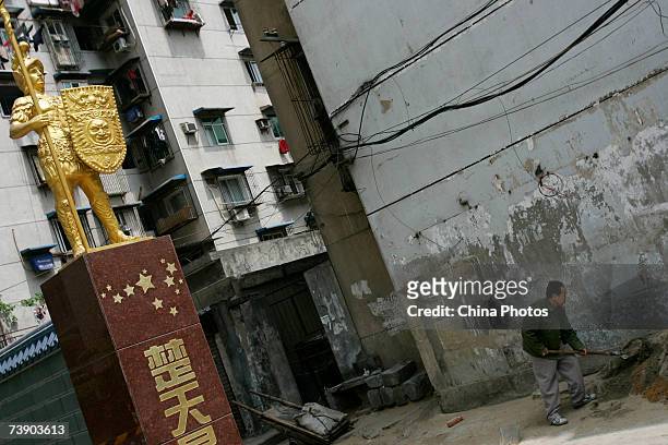 Worker works at a construction site beside a sign of a deluxe property on April 16, 2007 in Wuhan of Hubei Province, China. According to data with...