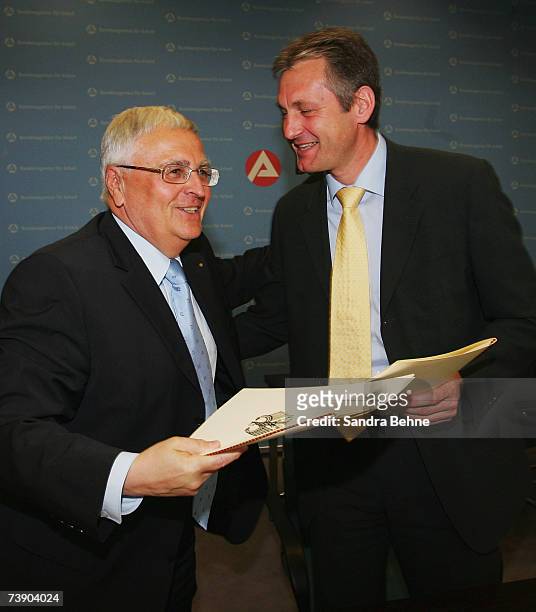 President of the German Football Association Dr. Theo Zwanziger and BA member of the board Raimund Becker shake hands after signing their contract...