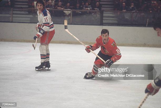 Canadian professional ice hockey player Ronald 'Chico' Maki of the Chicago Blackhawks skates on the ice as an opponent looks on during a game against...