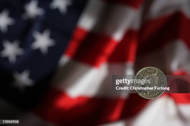 In this photo illustration a British pound coin can be seen next to the American Flag on April 17, 2007 in Manchester, England. The British Pound has...