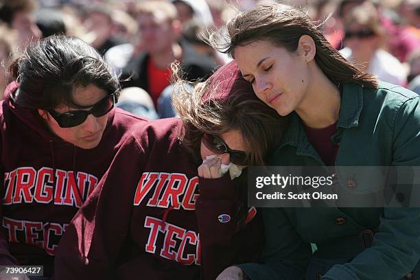 Virginia Tech students comfort each other on the field of the football stadium at a memorial service to honor those killed in yesterday's shootings...