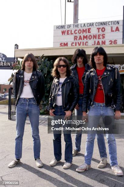 Johnny Ramone, Tommy Ramone, Joey Ramone and Dee Dee Ramone of the rock and roll band "The Ramones" pose for a portrait holding letters that spell...