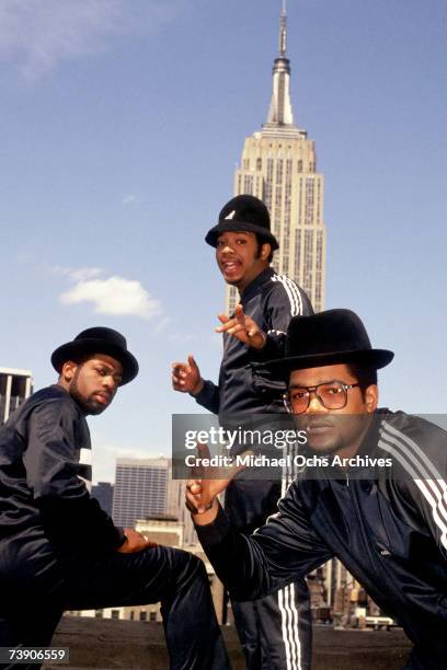 Joseph Simmons, Darryl McDaniels and Jam Master Jay of the hip-hop group "Run DMC" pose for a portrait session wearing Addidas sweat suits in front...