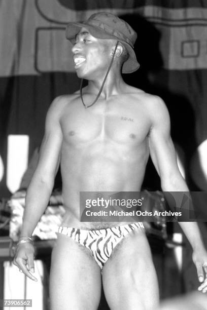 Rapper Tupac Shakur performs onstage with the hip hop group "Digital Underground" in 1991 in Los Angeles, California.