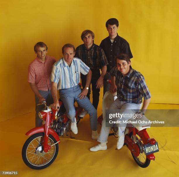 Rock and roll band "The Beach Boys" pose for a portrait with 2 Honda Mo-peds in circa 1964 in Los Angeles, California. Al Jardine, Mike Love, Dennis...