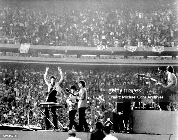 The Beatles perform at Shea Stadium, New York on 15th August 1965.