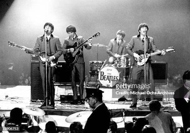 Rock and roll band "The Beatles" perform onstage at the Washington Coliseum on February 11, 1964 in Washington, D.C. Paul McCartney, George Harrison,...