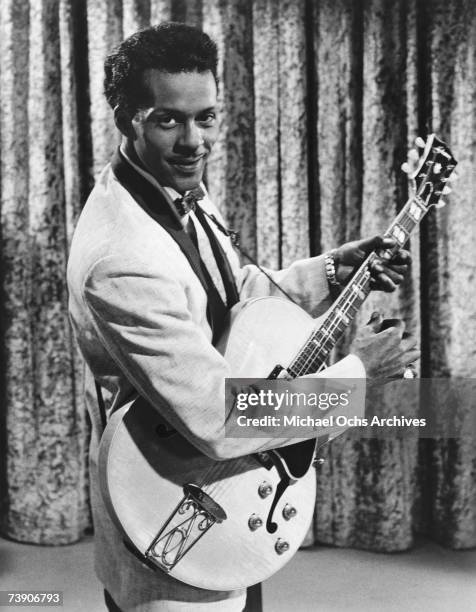 Rock and roll musician Chuck Berry poses for a portrait holding a Gibson hollowbody electric guitar in a scene from the movie "Go Johnny Go" which...