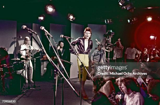 Musician David Bowie performs with his band including Mick Ronson on guitar on the Midnight Special TV show in 1973.