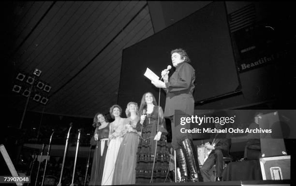 Country singer/songwriter Johnny Cash performs onstage with the Carter Sisters at the Anaheim Convention Center on March 11, 1978 in Anaheim,...