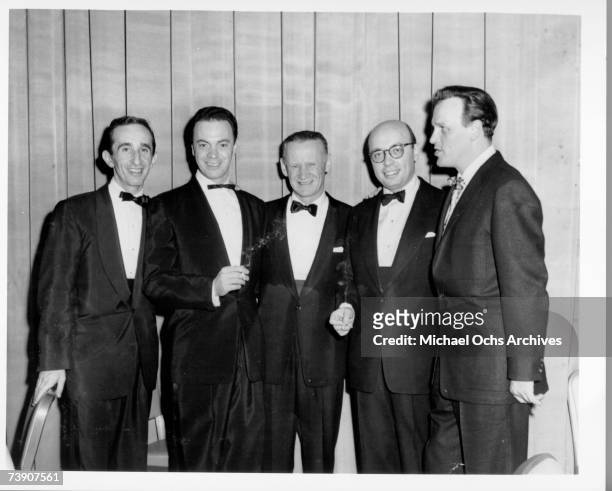Rock n' roll impresarios Alan Freed, Sammy Kaye, Ahmet Ertegun, Eddy Arnold pose for a portrait with an unidentified man in circa 1955.