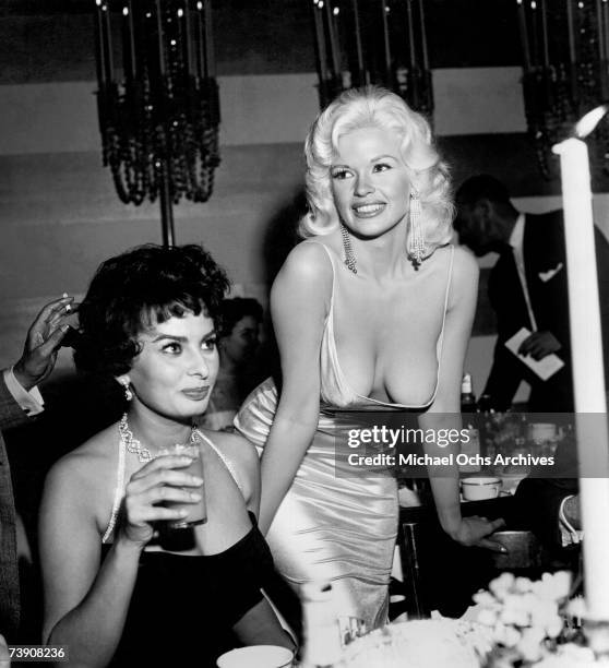 Jayne Mansfield attempts to steal the show at a 20th Century-Fox party to promote Sophia Loren on April 12, 1957 in Los Angeles, California.