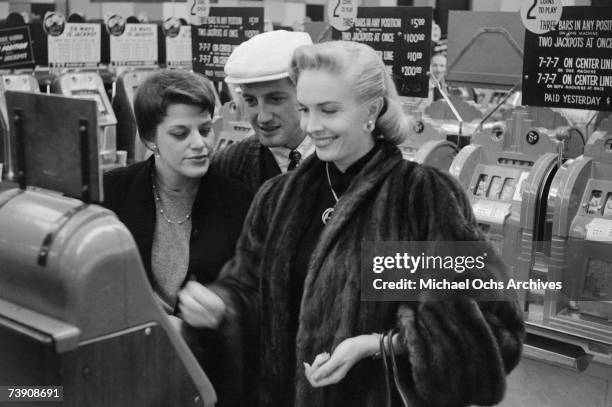 1950s, Nevada, Las Vegas, Playing the slot machines in the Flamingo Hotel casino.