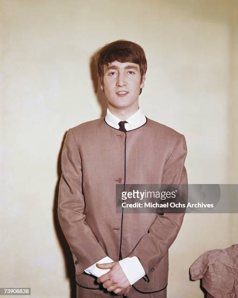 Singer and guitarist John Lennon of the rock and roll band "The Beatles" poses for a portrait wearing a suit in circa 1963 in London, England.