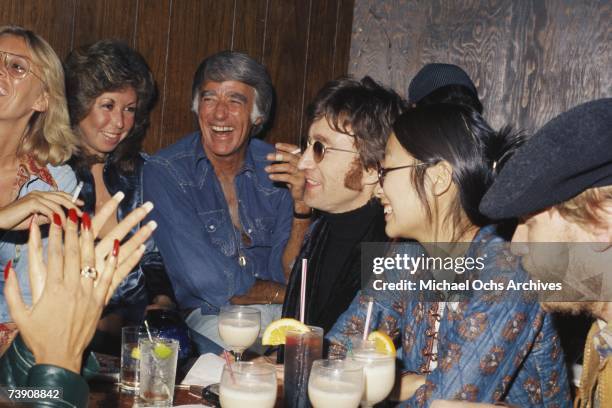 Singer-guitarist John Lennon, formerly of The Beatles, attends a Smothers Brothers comedy performance with girlfriend May Pang and fellow...