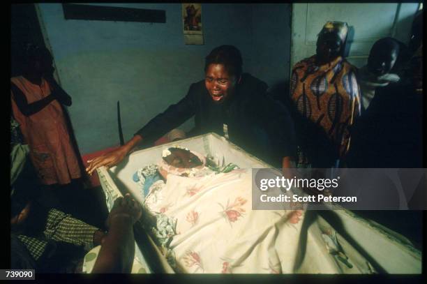 Mourners express their grief for Tereza Francisco Manuel who died attempting childbirth February 12, 1994 in Malange, Angola. In war-torn Angola the...
