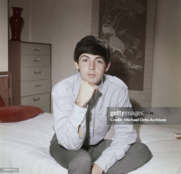 Bassist Paul McCartney of the rock band "The Beatles" poses for a portrait sitting on a bed in circa 1964 in London, England.