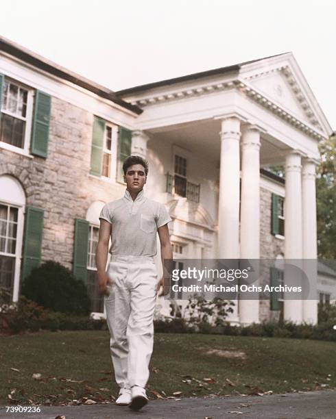 Rock and roll singer Elvis Presley strolls the grounds of his Graceland estate in circa 1957.