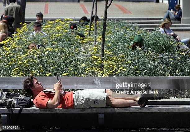 Berkeley student uses a handheld device while lounging on the UC Berkeley campus April 17, 2007 in Berkeley, California. Robert Dynes, President of...