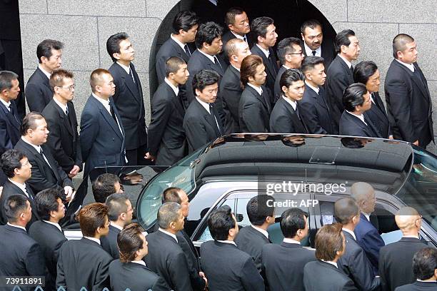 This 20 April 2002 picture shows members of Japan's largest organised crime syndicate, the Yamaguchi-gumi gathering at a funeral of their boss in...