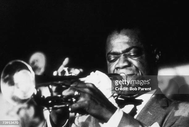 American jazz singer and trumpeter Louis Armstrong in concert at the Basin Street Cafe, New York City, 27th June 1956.