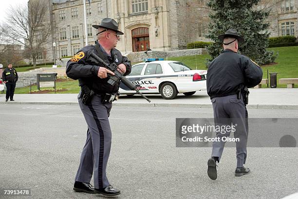 Virginia State Troopers resopnd to a perceived threat at Virginia Tech's Burruss Hall which, sits next to Norris Hall where on Monday a gunman shot...