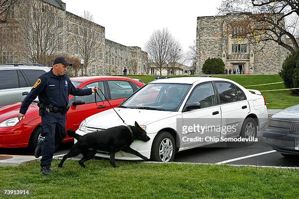 Virginia State Police use explosive sniffing dogs to search cars parked in front of Burrus Hall and Norris Hall after reports of a security alert on...