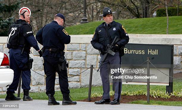 Virginia State police stand watch outside Burruss Hall and Norris Hall after reports of a security alert on the campus of Virginia Tech April 18,...
