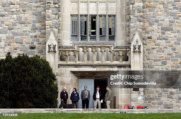 Investigators stand outside Norris Hall following being evacuated after reports of a security alert on the campus of Virginia Tech April 18, 2007 in...