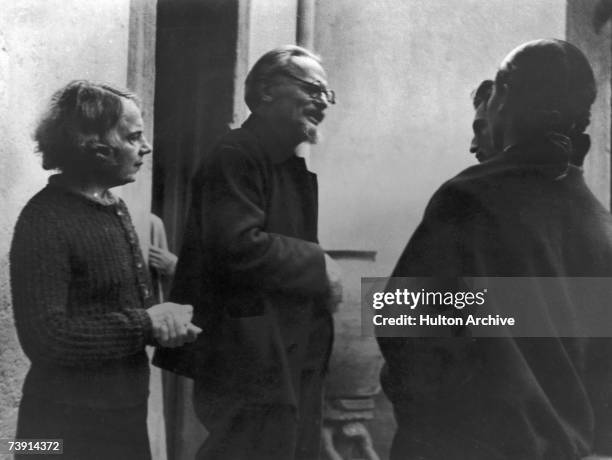 Russian revolutionary Leon Trotsky and his wife Natalia Sedova in conversation with Trotsky's secretary and hostess , circa 1936.