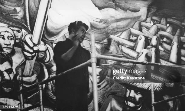 Mexican artist David Alfaro Siqueiros working on a mural in the Hall of the Revolution in Chapultepec Castle, circa 1960