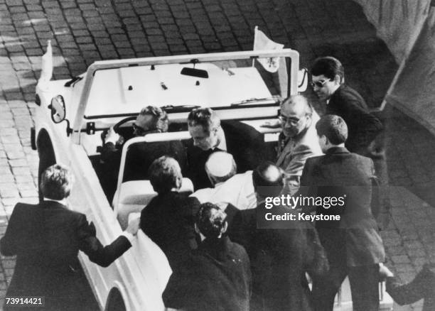 Pope John Paul II is driven away from St Peter's Square, having been shot by would-be assassin Mehmet Ali Agca, 13th May 1981.