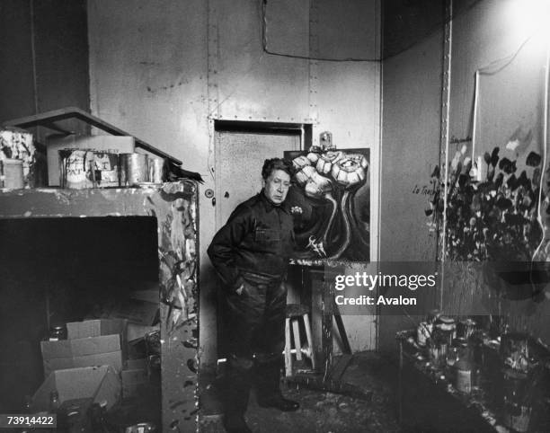 Mexican artist David Alfaro Siqueiros with some of his paintings in his prison cell, 17th November 1966. He was imprisioned by the government for...