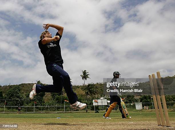 Shane Watson of Australia bowls with captain Ricky Ponting looking on during training at La Sagesse Cricket Ground on April 18 in St George's,...