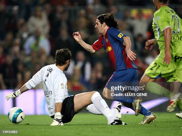 Barcelona's Argentine Leo Messi vies with Getafe's goalkeeper Luis before scoring the second goal during their Spanish King's Cup football match, 18...
