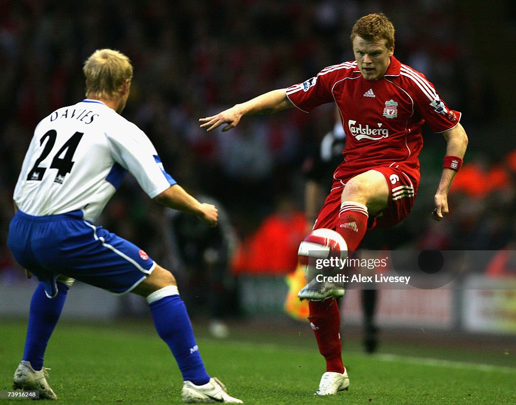 V Riise John Arne Riise of Liverpool receives the ball under pressure from ...