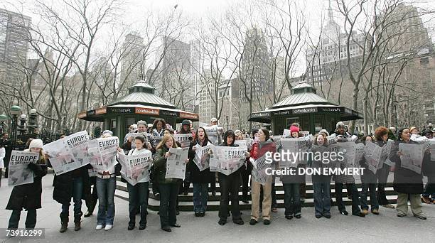 New York, UNITED STATES: Members of a 100-person choir sing at the corner of 6th Ave and 42nd Street in New York City 18 April 2007. The group...